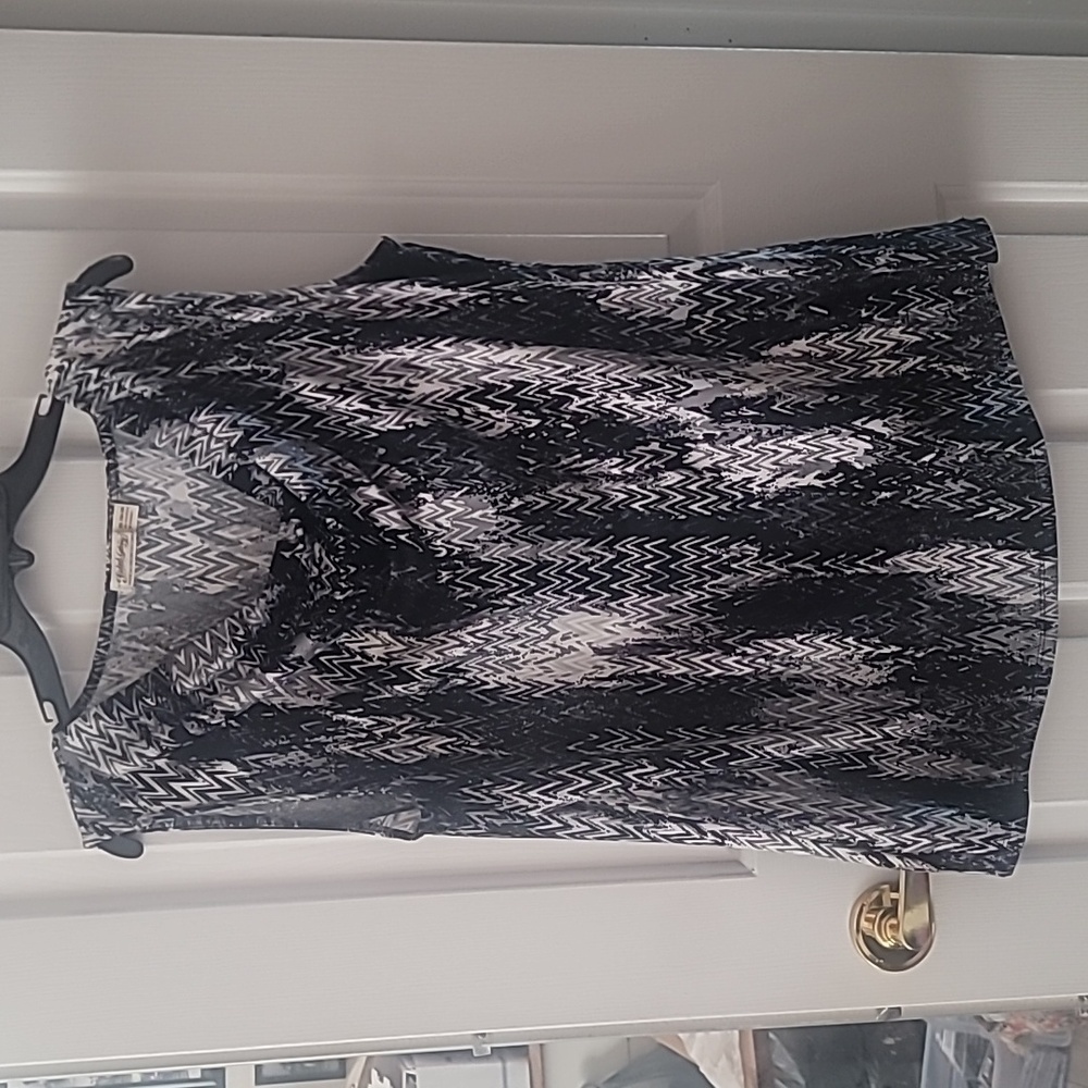 Sleeveless blouse with mock cowl neckline.